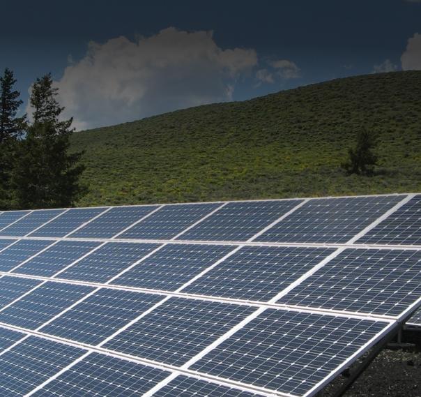 Array of solar panels on a grassy field.